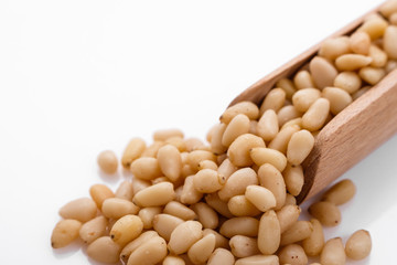 peeled pine nuts on a white acrylic background