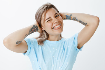 My braces are awesome. Portrait of cute confident and happy young woman in trendy t-shirt, holding...