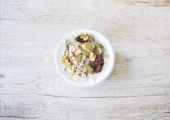 top view muesli  in bowl on wooden background, granola healthy meal, food diet concept