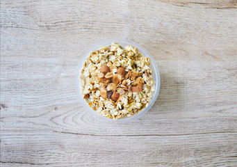 close up  top view muesli in bowl on wooden background, granola healthy meal, food diet concept