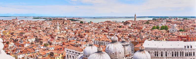 Fototapeta na wymiar View over Venice and its different quarters / Architecture, rooftops and houses of Venice in Italy seen from St. Mark's Tower
