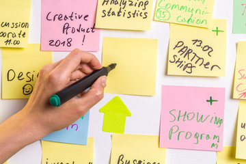 Business people write down an important note, using on the paper stickers post it. The hand of a...