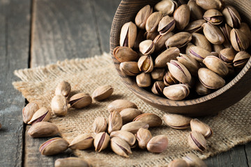 Healthy mix nuts on wooden background. Almonds, hazelnuts, cashews, peanuts, pistachios, brazilian nuts