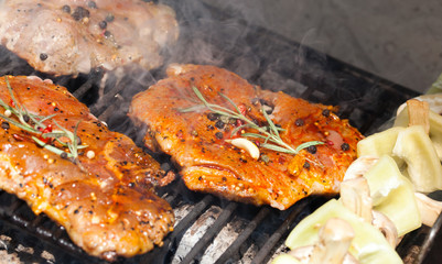 meat with  herbs grilling on barbecue