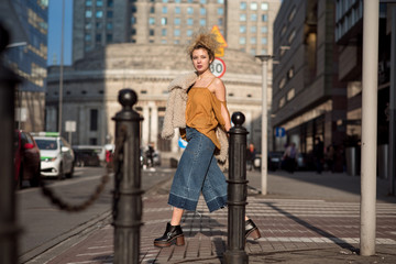 Naklejka premium beautiful girl walking through the city streets