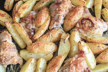 Fried potatoes with chicken with golden crust in the oven