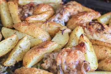 Fried potatoes with chicken with golden crust in the oven