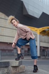 beautiful girl walking through the city streets