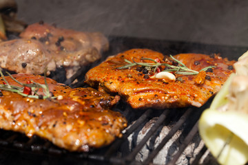 meat with  herbs grilling on barbecue