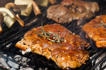 meat with  herbs grilling on barbecue