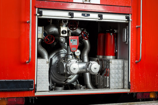 Compartment of rolled up fire hoses on a fireengine. Emergency safety. Protection, rescue from danger.