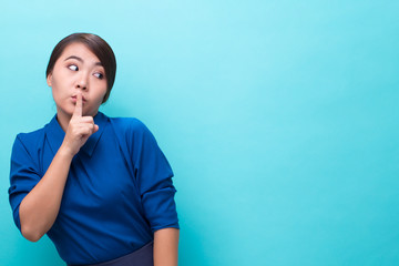 Asian woman making quiet gesture on isolated background