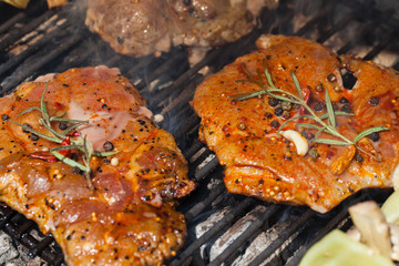 meat with  herbs grilling on barbecue