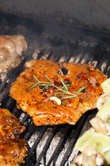 meat with  herbs grilling on barbecue