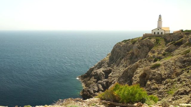 Idyllic view of lighthouse at Cala Rajada, rocky coast cliffs on Mallorca, Spain Mediterranean Sea