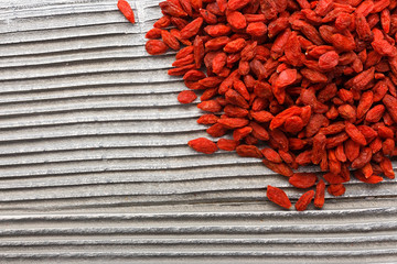 dried goji berries on a wooden rustic background