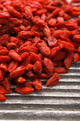 dried goji berries on a wooden rustic background