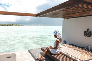 sexy girl  with white towel on her body relaxing on Maldive's villa outdoor bathroom