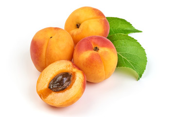 Fresh whole apricots with leaf and half with core, isolated on white background.
