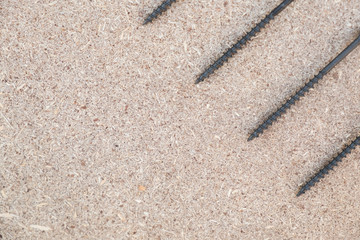 Background with copy space on the hobby, DIY, hand tools, house repairing theme. Screws on the wooden board.