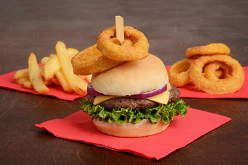 closeup of a hamburger with onion rings on top