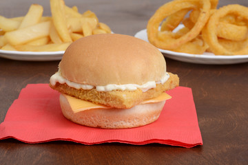 closeup of fillet fish sandwich on red napkin