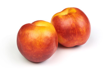 Fresh sweet nectarines, isolated on white background.