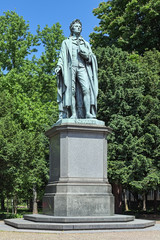 Obraz premium Schiller monument at the Taunusanlage park in Frankfurt am Main, Germany. The monument by sculptor Johannes Dielmann was unveiled on May 9, 1864.