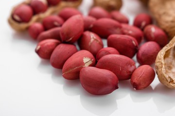 fresh peanuts on a white acrylic background