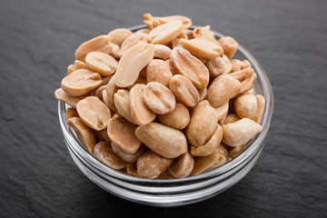 fresh peanuts on a dark stone background