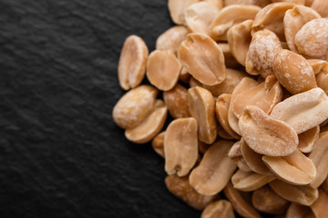 fresh peanuts on a dark stone background