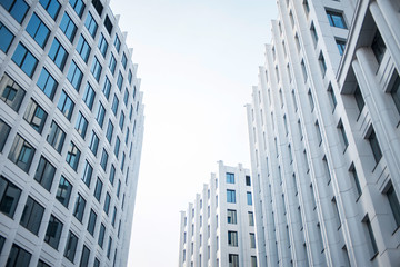 facade of white buildings in the business quarter. Not fully glass facades