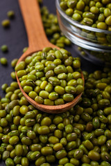 fresh Mung beans on a dark stone background