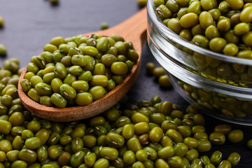 fresh Mung beans on a dark stone background