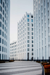 Fototapeta premium facade of white buildings in the business quarter. Not fully glass facades