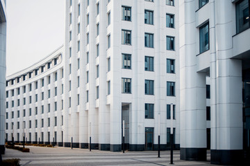 facade of white buildings in the business quarter. Not fully glass facades