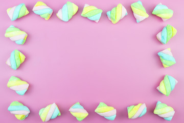 Flat lay top view tasty appetizing concept, minimal Sweet Treat Swirl Candy Lollipop marshmallow Colorful pattern on pink pastel background and copy space.