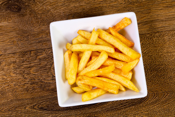 French potato over wooden background