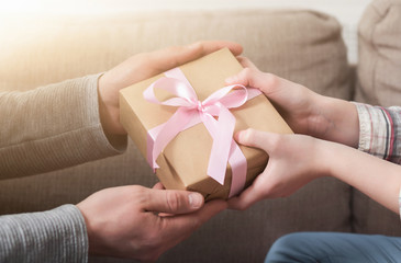 CLoseup of father hands gives gift to daughter