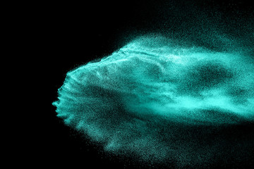 Green sand explosion isolated on black background. Abstract sand cloud. Green sand splash against ...