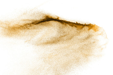 Golden sand explosion isolated on white background. Abstract sand cloud. Gold sand splash against...