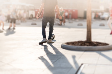 Young guys playing street football outdoors in hot summer day