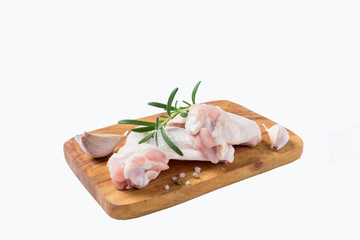 Raw chicken wings on cutting board on a white background..Shallow DOF