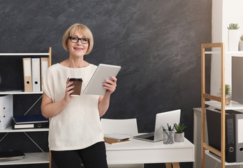 Modern businesswoman with digital tablet in office