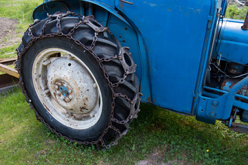 Fototapeta na wymiar tires on a blue tractor standing i gras