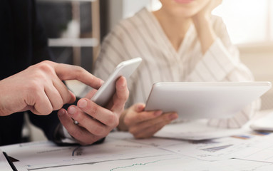 Couple of business partners working with gadgets