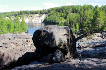 black large stone in the form of a dog's head in place of an extinct volcano Girvas. Karelia, Russia