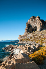 Fototapeta na wymiar Cave rock and yellow sagebush of Lake Tahoe in Summer, Navada, USA