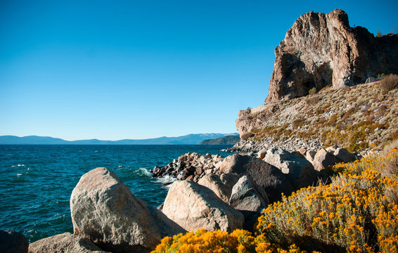 Cave rock and yellow sagebush of Lake Tahoe in Summer, Navada, USA