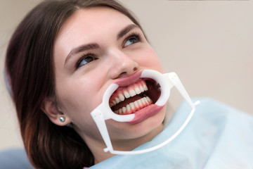 doctor orthodontist performs a procedure for cleaning teeth